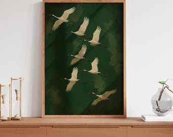 May include: A framed print of a flock of white cranes flying in formation against a dark green background.