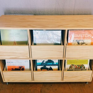 A 6-drawer record cabinet in birch with LPs inside the drawers.