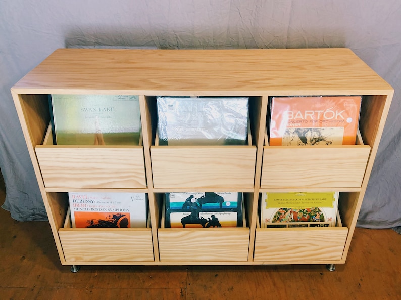 A 6-drawer record cabinet in birch with LPs inside the drawers.