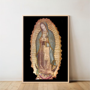May include: A framed print of Our Lady of Guadalupe. The artwork depicts a religious figure with hands clasped in prayer, wearing a blue robe and surrounded by a golden halo against a black background. The print is in a wooden frame.