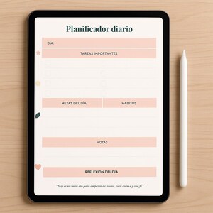 May include: A digital tablet displaying a daily planner with sections for tasks, goals, habits, notes, and daily reflection. The text "Planificador diario" is at the top. A white stylus rests beside the tablet on a light wood surface.