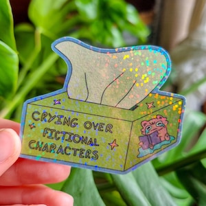 Sticker "Boite à mouchoir crying over fictional character" | Sticker holographique | Illustration mignonne | Cadeau amoureux des livres