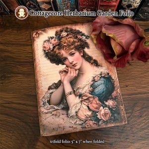 May include: A trifold folio measuring 5 inches by 7 inches when folded, featuring a vintage-style illustration of a person with curly hair adorned with roses, wearing a blue dress, with the text Cottagecore Herbarium Garden Folio printed above.