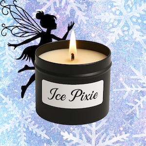 Peut inclure: Un bocal de bougie noir avec une étiquette blanche sur laquelle est inscrit "Ice Pixie". La bougie est allumée et le bocal est entouré d'un motif de flocons de neige bleus et blancs.
