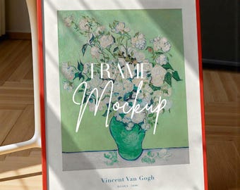 May include: A framed print of Vincent Van Gogh's "Roses 1890" artwork. The print features a bouquet of white roses in a green vase against a light green background. The frame is a vibrant red, and the words "FRAME Mockup" are overlaid on the image.