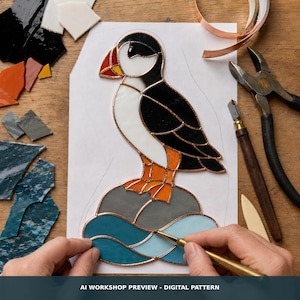 May include: A stained glass project of a puffin standing on a rock above blue waves, featuring black, white, and orange glass pieces joined by copper foil. The design includes the text AI WORKSHOP PREVIEW - DIGITAL PATTERN at the bottom.