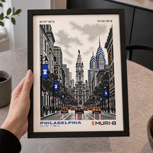 May include: A framed art print featuring a stylized illustration of Philadelphia city streets, including the City Hall tower, skyscrapers, blue banners with a bell icon, and yellow cars. The text reads Philadelphia, Muri-8, and coordinates.