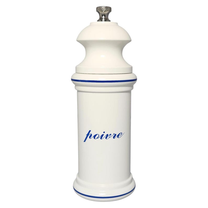 May include: A white ceramic pepper mill with a blue stripe detail and a stainless steel top. The word "poivre" is written in blue script on the front. A kitchen accessory.