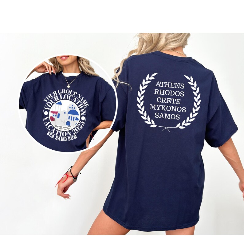 May include: Navy blue t-shirt featuring a white graphic on the front with the words "Vacation 2023" and a circular design. The back displays a laurel wreath design with Greek island names. A relaxed-fit, comfortable tee.