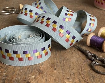 83 cents a foot - 10 yd roll of Grosgrain 1" Ribbon w/ embroidery of checks in purple, yellow & dark rose- pink background. New/old stock