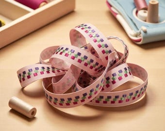 83 cents a foot - 10 yd roll of Grosgrain 1" Ribbon w/ embroidery of checks in purple, green & wine - pink background. New/old stock