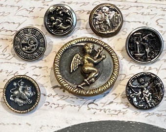Choice of 7 Antique Cupid / Putti / Cherub Victorian Buttons - stamped brass. Cupid w/ half moon