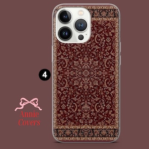 May include: A clear phone case with a red and gold patterned design that resembles a rug. The case is designed for an iPhone with a camera bump.