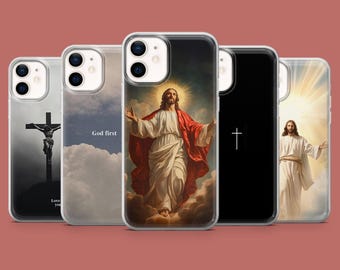 May include: Five different iPhone cases with religious imagery. The cases feature a cross, a silhouette of Jesus on the cross, a painting of Jesus ascending to heaven, and a painting of Jesus with a halo. The text "God first" is printed on one of the cases.