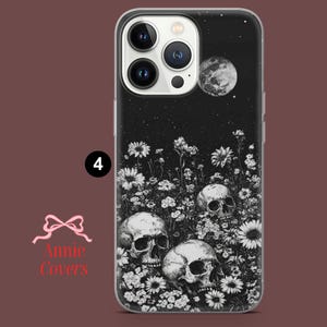 Puede incluir: Carcasa de tel&eacute;fono en blanco y negro con un dise&ntilde;o de tres calaveras rodeadas de flores y una luna creciente. El fondo es una noche estrellada negra.