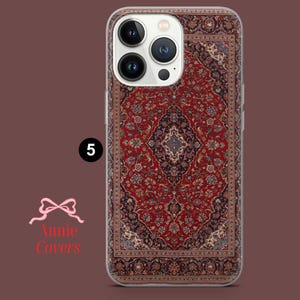 May include: A clear phone case with a red, blue, and white patterned design that resembles a Persian rug. The case is designed for an iPhone with a camera bump.