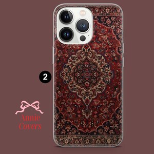 May include: A clear phone case with a red, black, and white patterned design that resembles a rug. The case is designed for an iPhone 13 Pro Max.