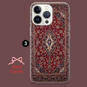 May include: A clear phone case with a red, blue, and white patterned design that resembles a rug. The case is designed for an iPhone with a camera bump.