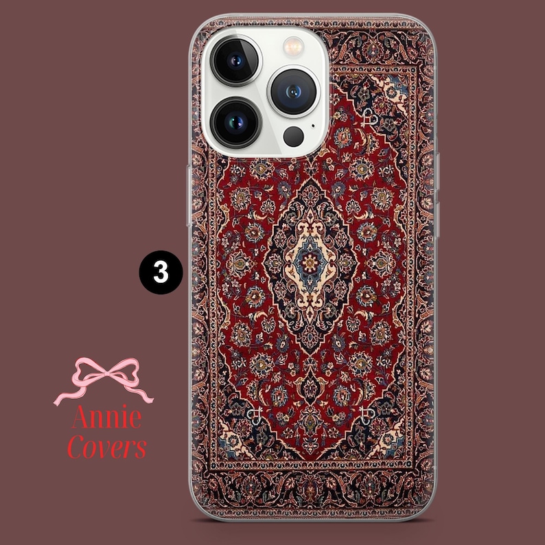 May include: A clear phone case with a red, blue, and white patterned design that resembles a rug. The case is designed for an iPhone with a camera bump.