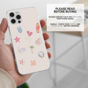 May include: A clear phone case with a light pink background featuring watercolor illustrations of a swimsuit, starfish, fins, a surfboard, a seashell, a palm tree, and a snorkel. The case also has text that reads "PLEASE READ BEFORE BUYING".