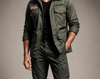 May include: An olive green military-style jacket with a U.S. flag patch and U.S. ARMY text, worn over a black t-shirt. The outfit includes matching olive green cargo pants and black leather combat boots. The ensemble features a structured collar.