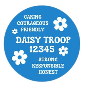 May include: A round, blue graphic with white text and flower illustrations. The text includes "CARING", "COURAGEOUS", "FRIENDLY", "DAISY TROOP", "12345", "STRONG", "RESPONSIBLE", and "HONEST".