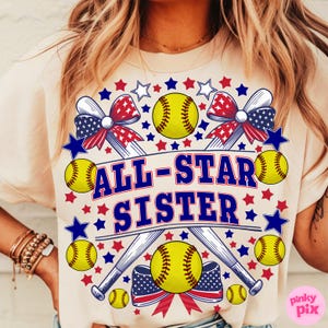 May include: Cream-colored t-shirt featuring a softball-themed design. The design includes yellow softballs, crossed baseball bats, and the text "ALL-STAR SISTER" in blue. Red, white, and blue stars and bows complete the patriotic theme.