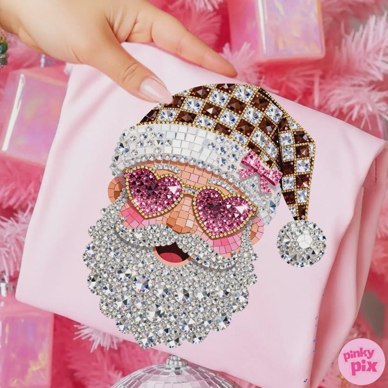May include: A light pink pouch featuring a mosaic-style graphic of Santa Claus wearing a brown and white checkered hat with a pink bow, heart-shaped pink sunglasses, and a white crystal-embellished beard, with the text Pinky Pix in the corner.