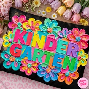 May include: A black pillow decorated with colorful, textured flowers and the word "KINDERGARTEN" in bright, block letters. The flowers are in shades of pink, yellow, blue, and orange.