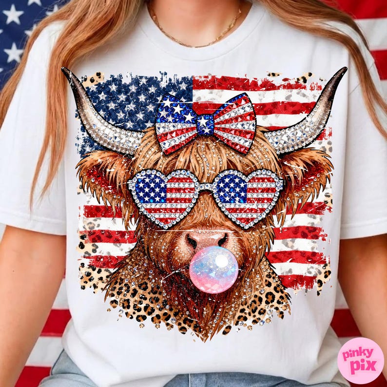 May include: White t-shirt featuring a Highland cow with patriotic sunglasses and a bow, all adorned with the American flag design. The cow is blowing a bubble, and the design includes a leopard print pattern.