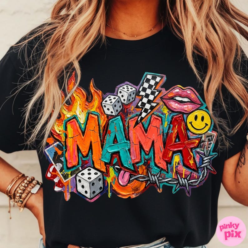 May include: Black t-shirt with a colorful graphic design that says "MAMA". The design includes flames, dice, a lightning bolt, lips, a smiley face, and barbed wire. The letters are in orange, teal, and red.