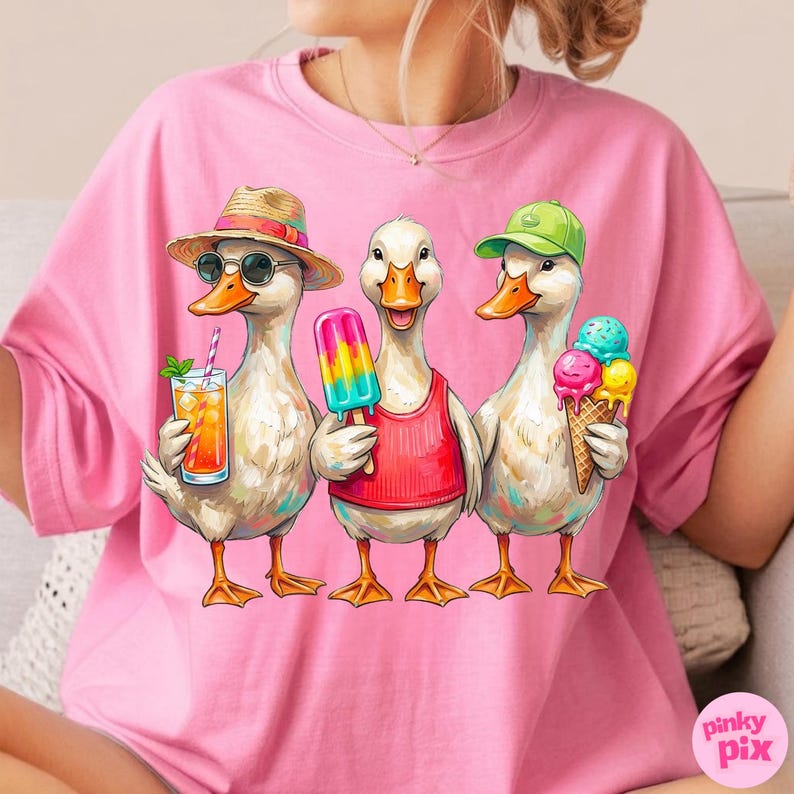 May include: Pink t-shirt featuring a graphic of three cartoon ducks enjoying summer treats. One duck wears a straw hat and sunglasses with a drink, another holds a popsicle, and the third has an ice cream cone. The shirt has the "pinky pix" logo.