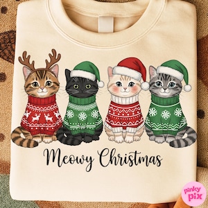 以下が含まれることがあります： クリスマスセーターと帽子をかぶった4匹の漫画の猫が描かれたクリーム色のスウェットシャツ。猫は、お祝いの模様が入った赤と緑のセーターを着ています。下のテキストは「Meowy Christmas」と書かれています。