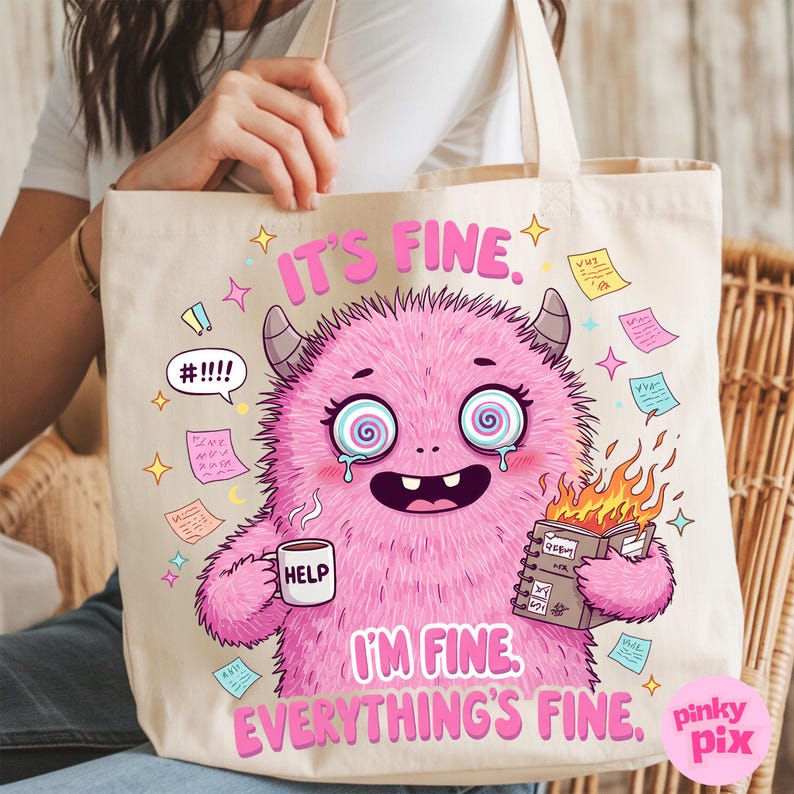 May include: A pink tote bag with a cartoon monster holding a cup that says "Help" and a burning notebook. The monster has a distressed expression and the text "It's fine. I'm fine. Everything's fine." is printed on the bag.