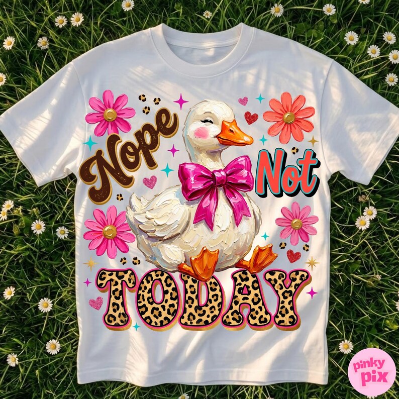 May include: White t-shirt featuring a whimsical duck with a pink bow, surrounded by flowers and the words "Nope Not Today." The text "TODAY" has a leopard print design. The shirt is decorated with hearts and stars.