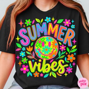 May include: Black t-shirt with a vibrant, colorful graphic. The design features the words "SUMMER VIBES" in bright lettering, a smiley face with floral details, and various flowers and stars. The overall theme is cheerful and summery.