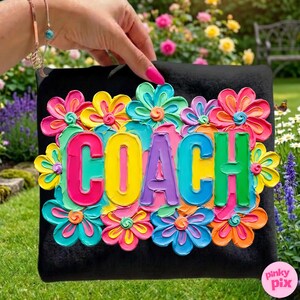 May include: Black square with the word "COACH" in colorful, raised lettering, surrounded by vibrant, textured flowers in shades of pink, yellow, blue, and orange. The design is set against a backdrop of a lush garden.