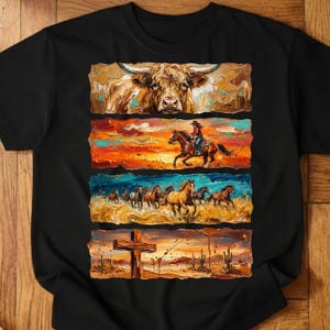 May include: Black t-shirt featuring a multi-panel design with a longhorn, a person riding a horse, a herd of horses, and a cross in a desert landscape. The artwork uses warm colors and a textured, painted style.