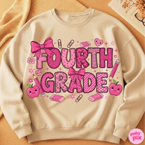 May include: Beige Fourth Grade sweatshirt with pink text and graphics. The text "FOURTH GRADE" is in a variety of pink patterns, with bows, pencils, erasers, and apple graphics. A cute and colorful design for back-to-school.