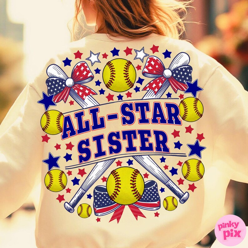 May include: Cream-colored sweatshirt with a softball-themed design. Features the text "ALL-STAR SISTER" in blue, surrounded by softballs, baseball bats, stars, and patriotic bows in red, white, and blue.