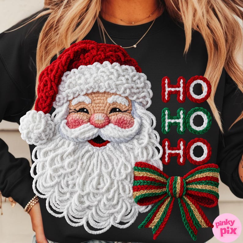 May include: Black sweatshirt featuring a crocheted Santa Claus design with a red hat, white beard, and pink cheeks. The text "HO HO HO" is displayed in red and green, with a red, green, and gold bow at the bottom. A festive holiday theme.