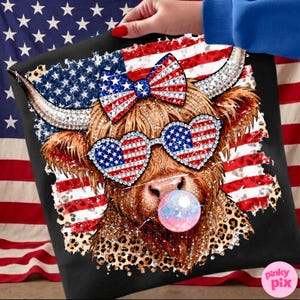 May include: Black pillow with a graphic of a Highland cow wearing heart-shaped sunglasses and a bow, both decorated with the American flag. The cow is blowing a bubble and has a leopard print pattern on its fur.