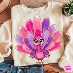 May include: Cream-colored sweatshirt featuring a cartoon turkey with a vibrant pink, purple, and gold glitter feather design. The turkey has big blue eyes and a pink body. The design is centered on the front of the sweatshirt.