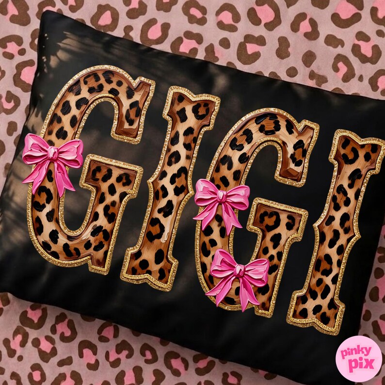 May include: Black rectangular pillow with the name "GIGI" in large, leopard print letters outlined in gold glitter. Pink bows are attached to the letters. The pillow is on a pink leopard print background.