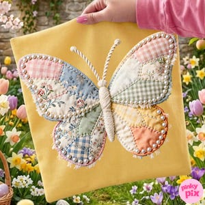 May include: A yellow fabric square featuring a large, three-dimensional butterfly appliqu&eacute;. The butterfly wings are constructed from quilted patches of floral, gingham, and solid fabrics in pastel tones, outlined with small white beads and fringe.