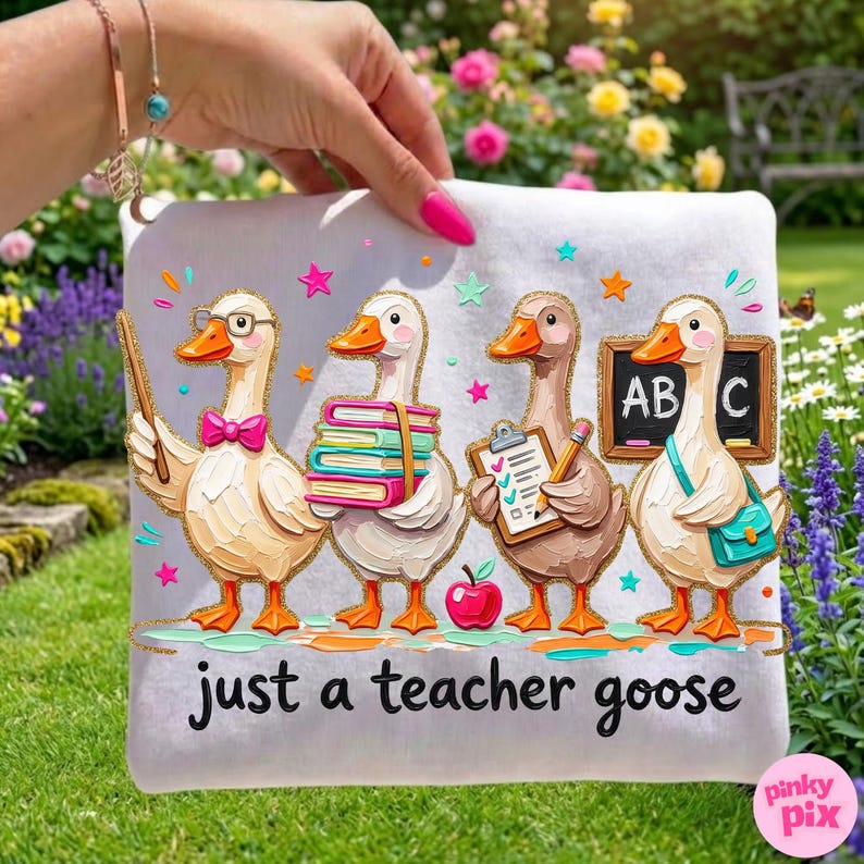 May include: A white decorative pillow featuring four cartoon geese in a row, each with a different teacher-themed accessory. The text "just a teacher goose" is at the bottom. The geese are on a green and gold glittery background.