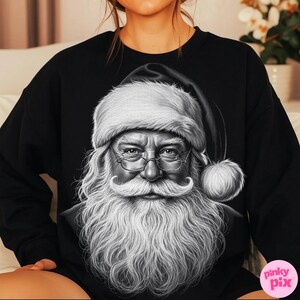 May include: Black sweatshirt featuring a detailed black and white illustration of Santa Claus. The image shows Santa with a long white beard, glasses, and a traditional hat. The design is centered on the front of the sweatshirt.