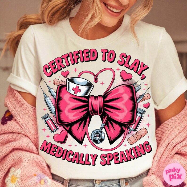 May include: White t-shirt with a pink bow design featuring medical elements like syringes, a nurse's hat, and a stethoscope. The text "CERTIFIED TO SLAY, MEDICALLY SPEAKING" is printed in pink.