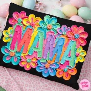 May include: Black decorative pillow with the word "MAMA" in colorful, textured lettering, surrounded by vibrant, multi-colored flowers. The pillow is a square shape.