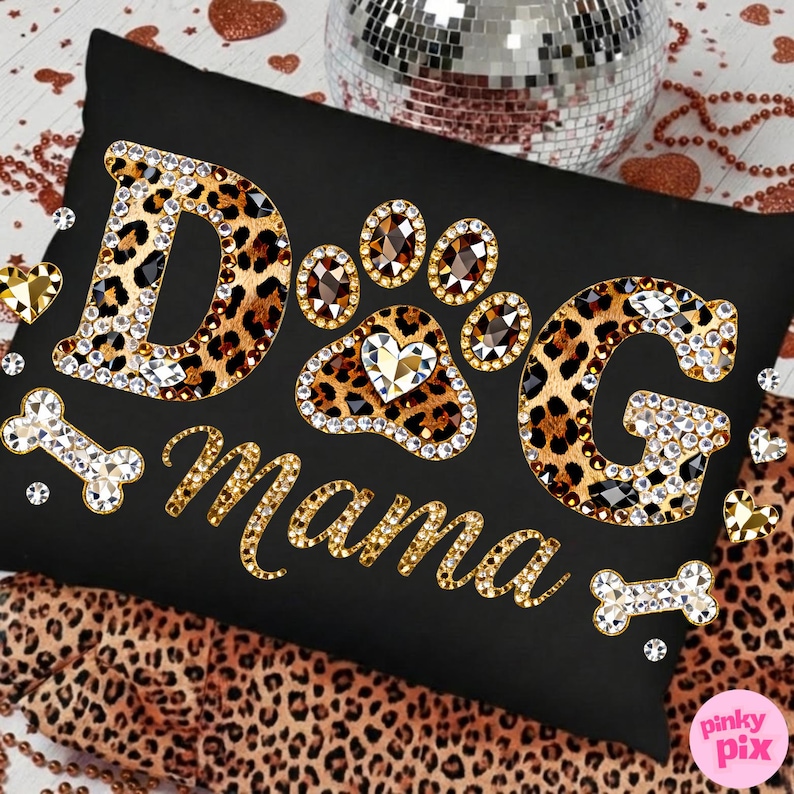 May include: Black rectangular pillow with the words "DOG Mama" in gold and rhinestone embellishments. The letters "DOG" are leopard print with rhinestone borders. A paw print and bone shapes are also decorated with rhinestones.